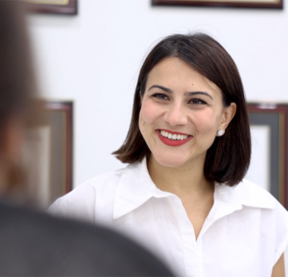 Oral surgery team member smiling at a patient