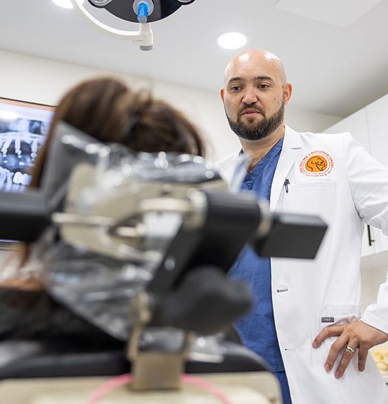 Dentist and oral surgeon discussing dental implant tooth replacement plan