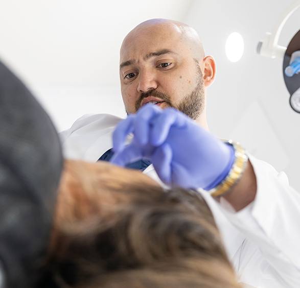 Oral surgeon treating a patient