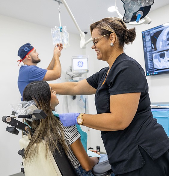 Oral surgery team member prepping a patient for their procedure