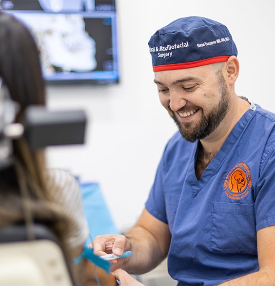 Oral surgeon talking to a patient before treatment