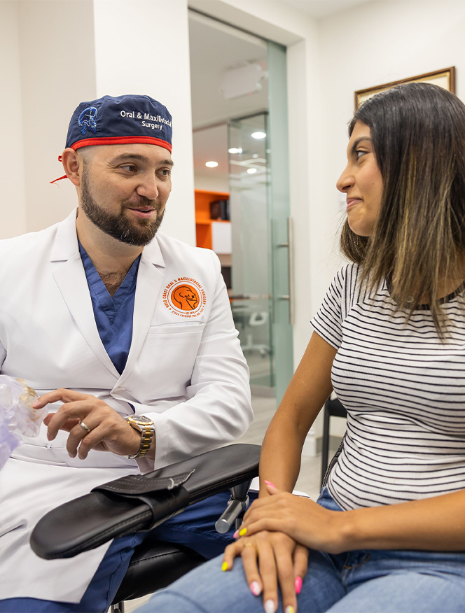 Roslyn New York oral surgeon Doctor Steve Yusupov talking to a patient