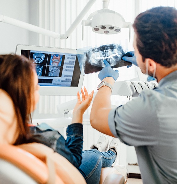 Oral surgeon and patient reviewing X-ray