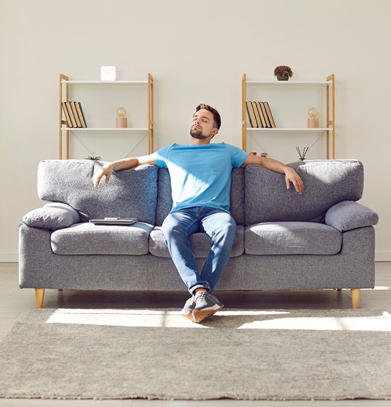 Man relaxing on his sofa at home