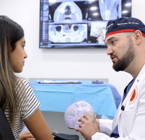 Oral surgeon explaining to a patient how Teeth in a Day in Roslyn works