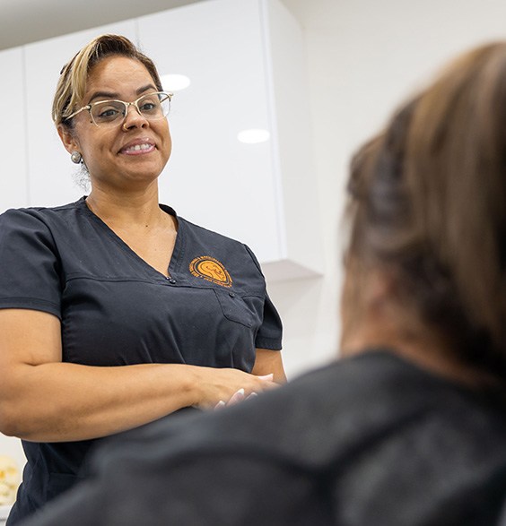 Oral surgery team member talking to a patient