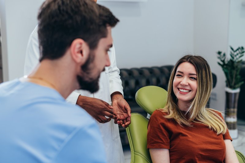 Woman smiling ahead of dental implant surgery with oral surgeon