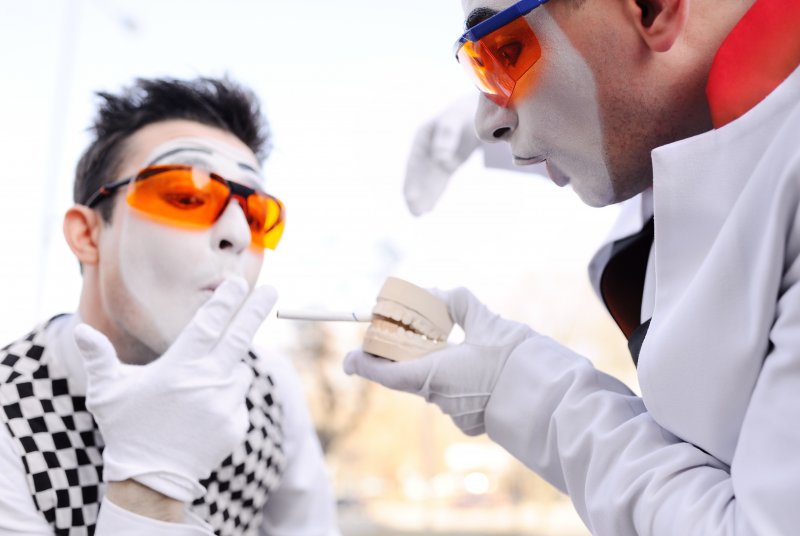 Mimes showing that smoking and dental implants aren't a good mix