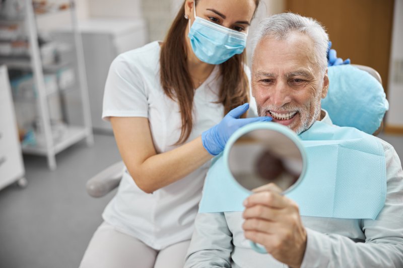 An older man enjoying his new dental implants
